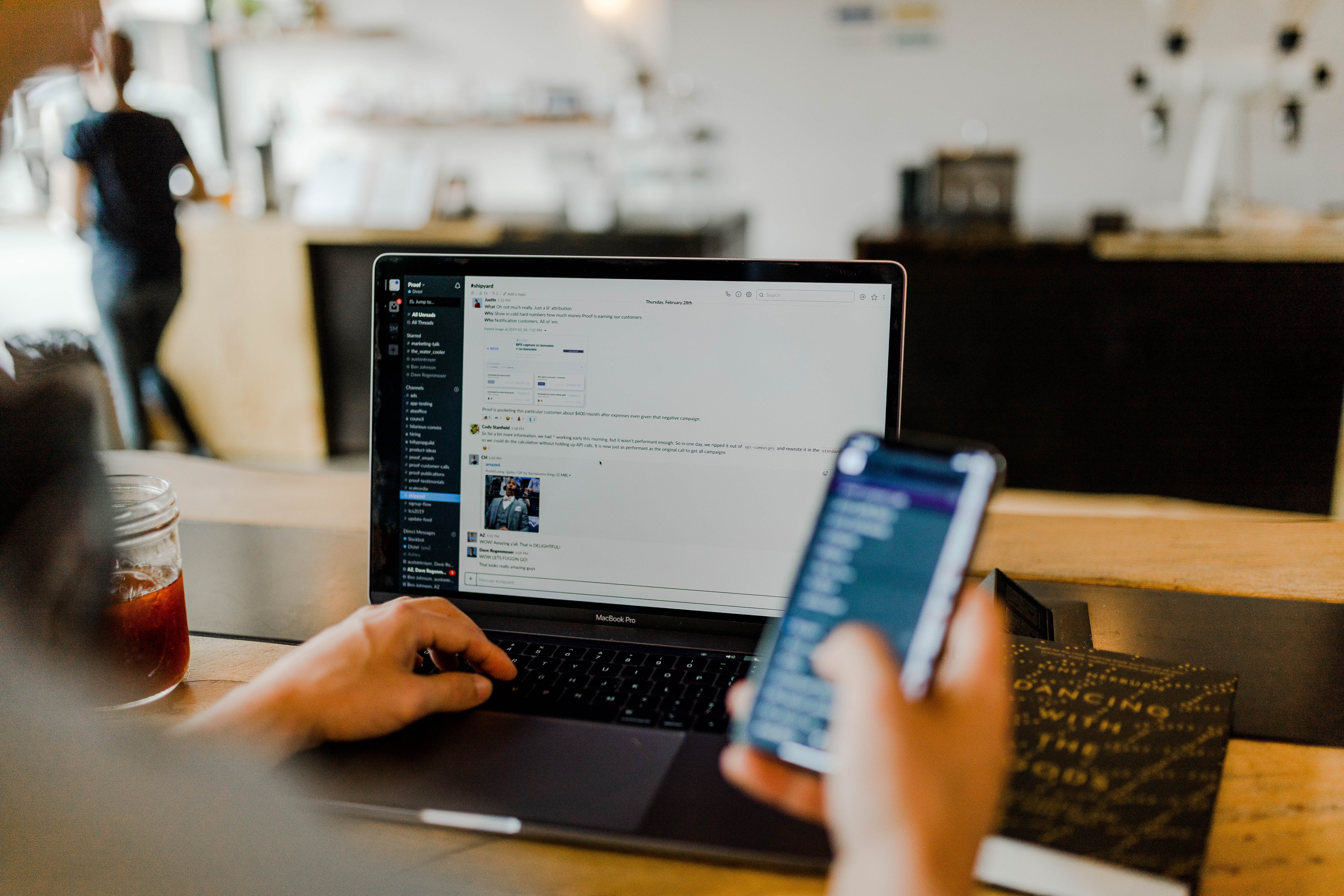 someone on a computer and phone engaging in a discussion forum 