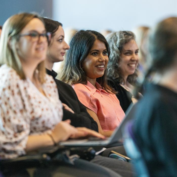 People smiling in auditorium