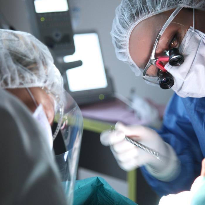 two surgeon operating on oral cancer 