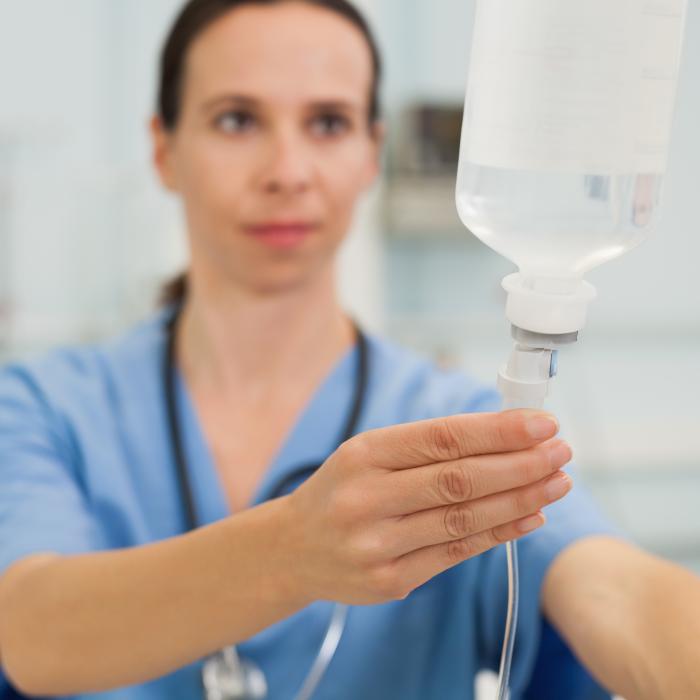 Nurse adjusting a drip