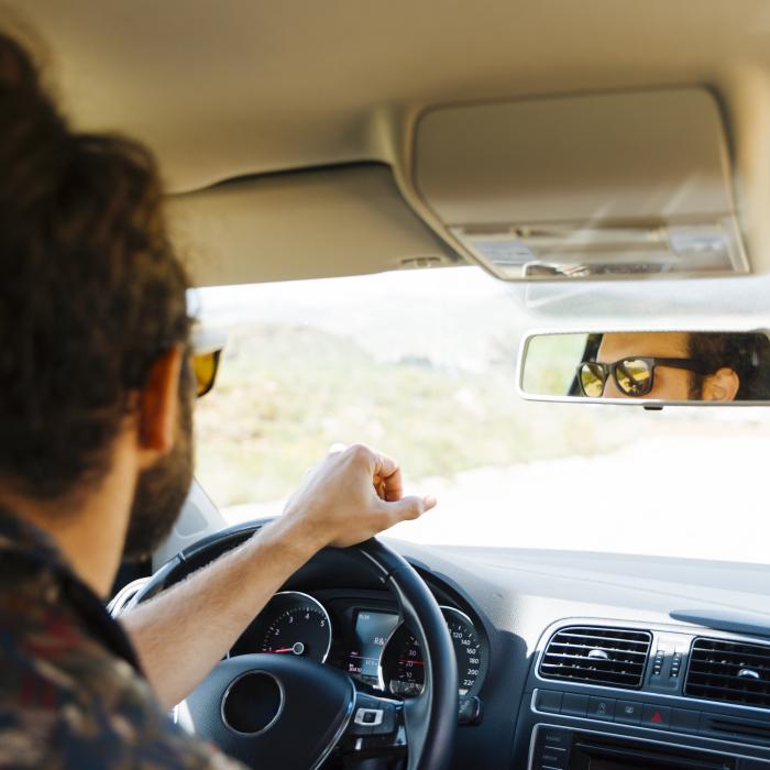 young-man-driving-car-sunny-day