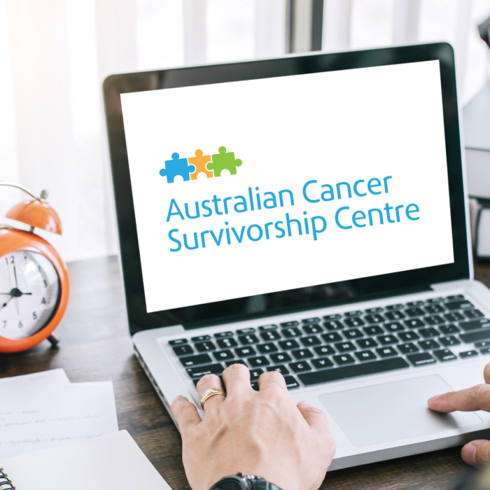 Person at laptop with Australian Cancer Survivorship Cousre logo