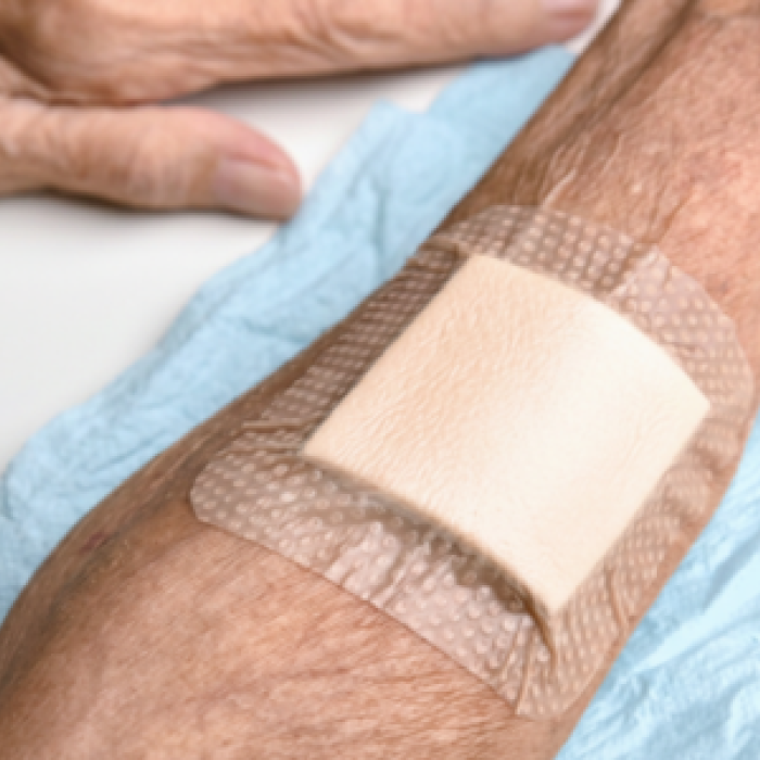 Arm with wound dressing - canva 