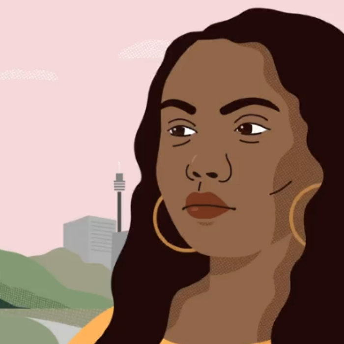 A profile image of a woman of colour wearing a yellow top, with brown long hair, brown eyes and yellow hoop earings. 