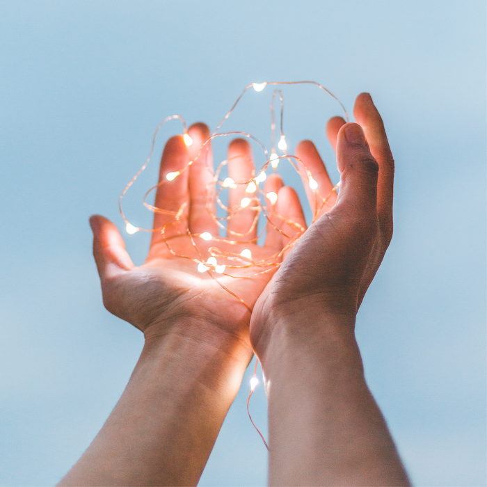 hands holding fairy lights